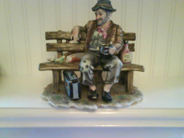 Tramp figurine on park bench with birds. Capodimonte with Mt Fuj