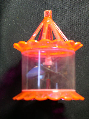 MID-CENTURY MODERN SHOCKING SALMON PINK TWIRLER HEAT ORNAMENTS, CIRCA