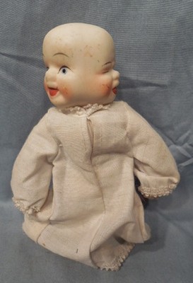 antique porcelain doll with 3 faces