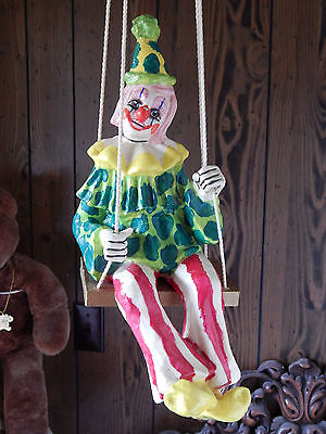 porcelain clown doll on swing