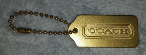 coach gold metal hang tag