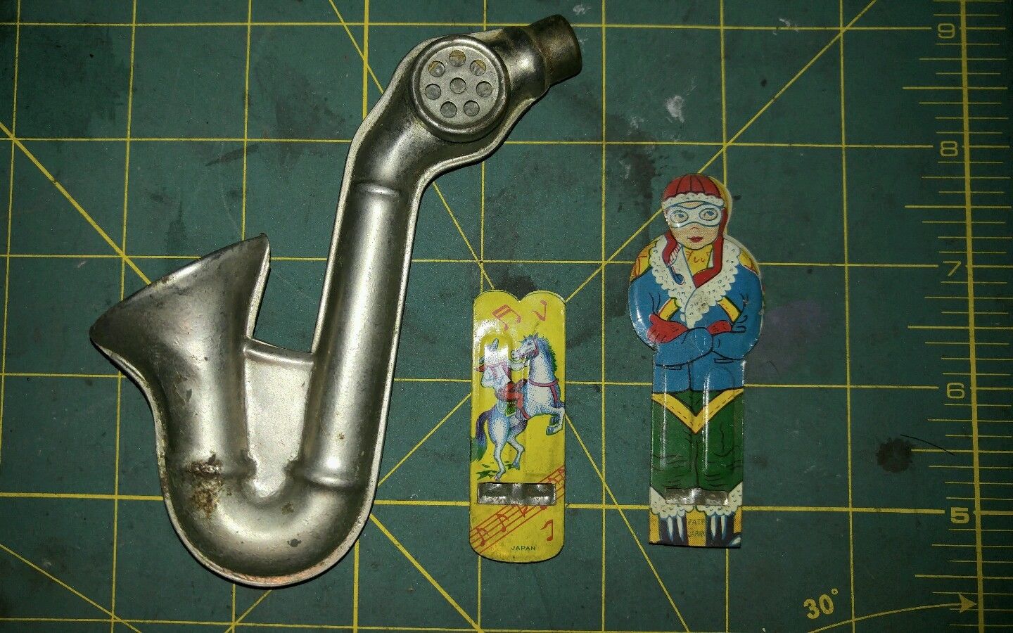 Vintage Tin lithograph cowboy pilot whistles kazoo saxophone Japan