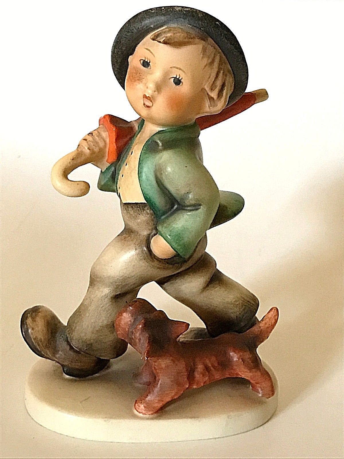 hummel boy with umbrella and dog