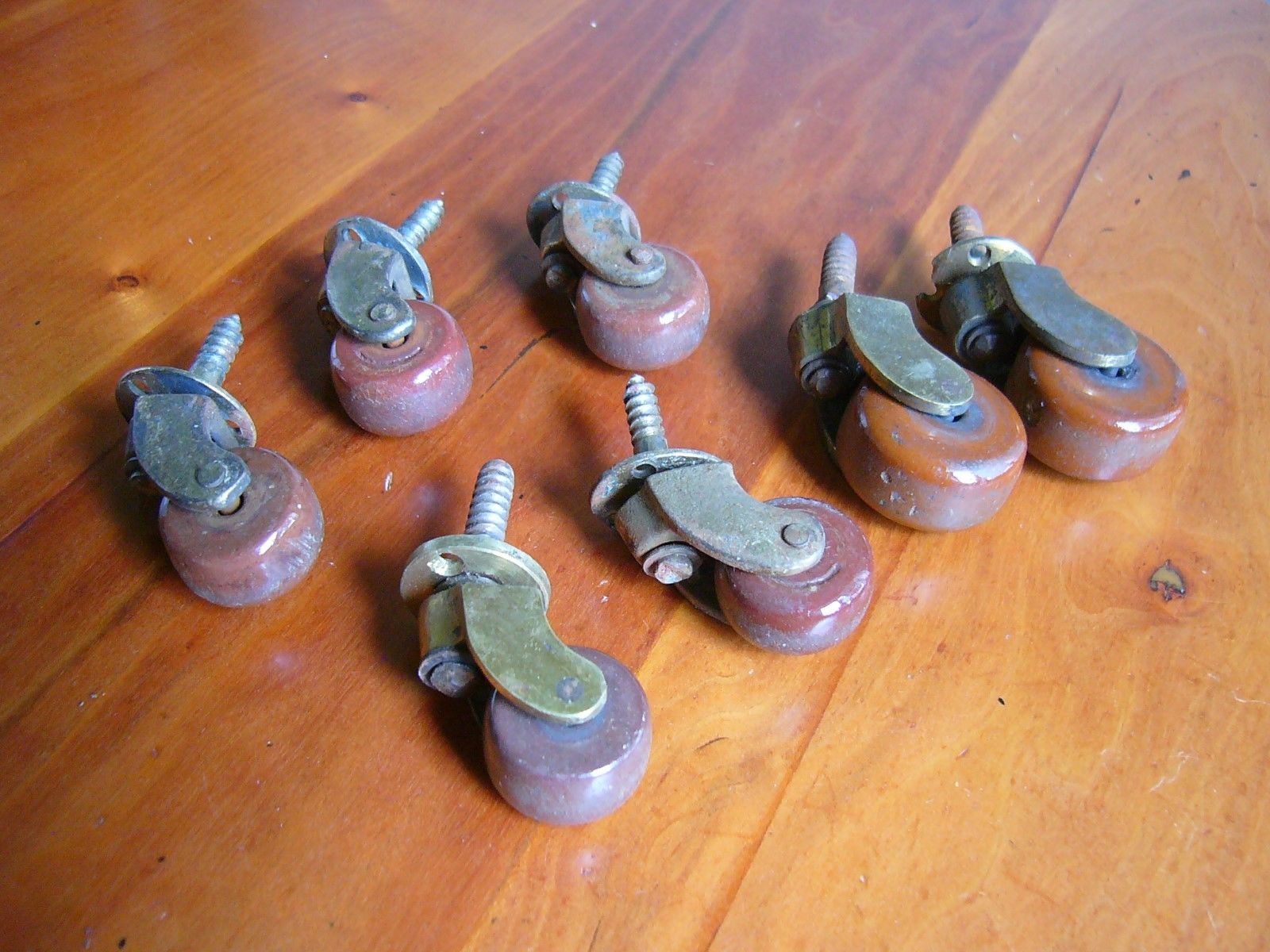 7 RECLAIMED ANTIQUE CERAMIC AND BRASS FURNITURE CASTERS. Antique