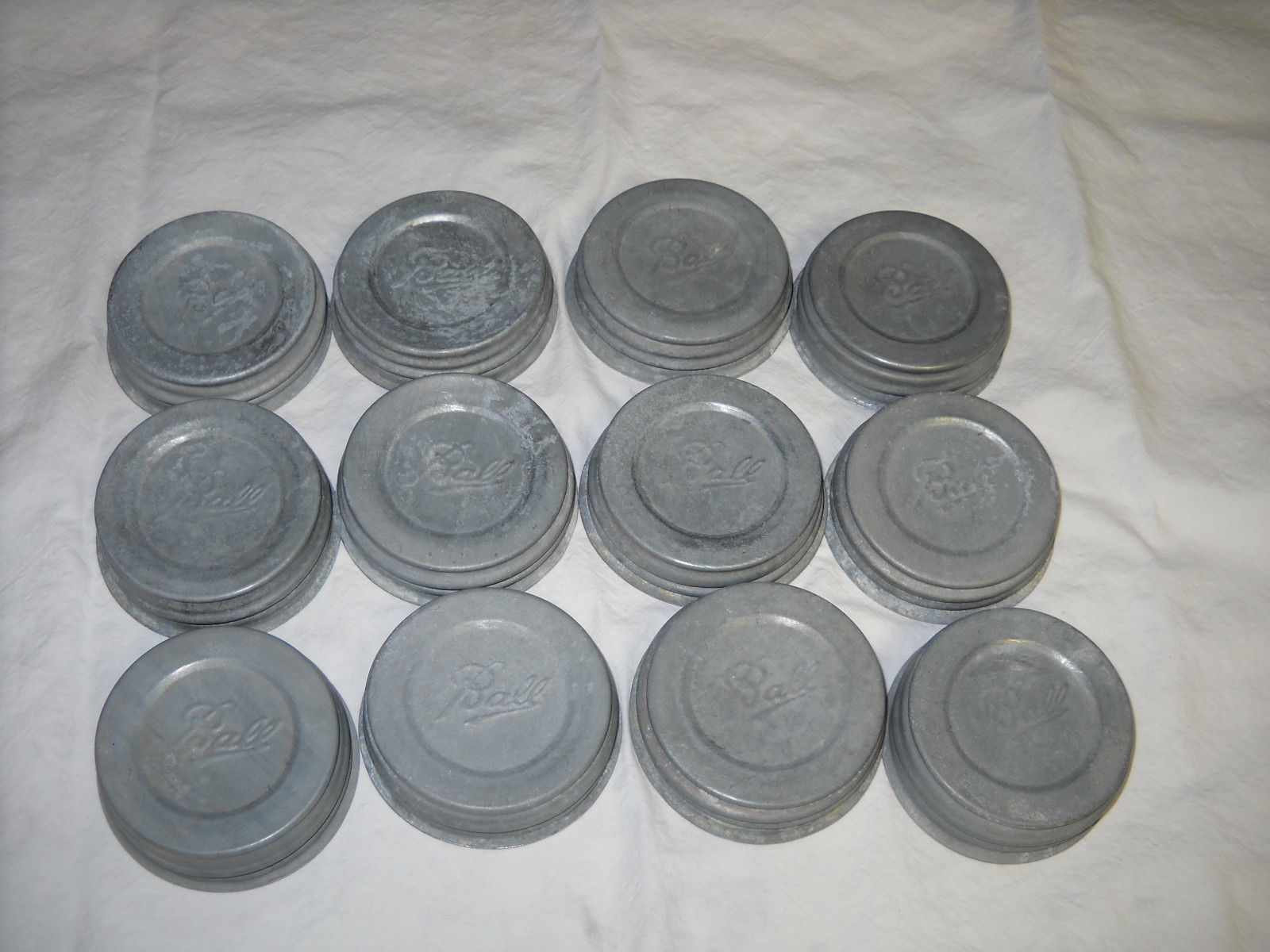 LOT OF 12 VINTAGE "BALL" CANNING JAR ZINC METAL LIDS W/MILK GLASS