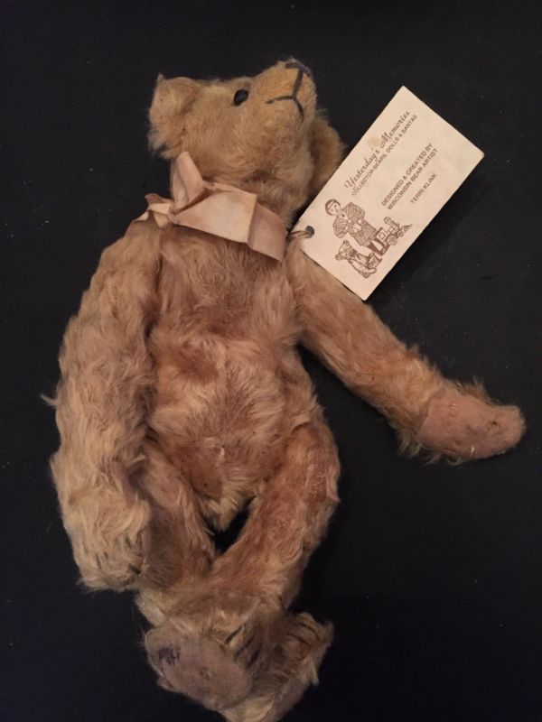 old teddy bear stuffed with straw